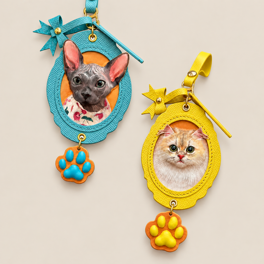 Blue and yellow PawRelic scalloped leather pet portrait charms with decorative bows and paw-shaped pendants