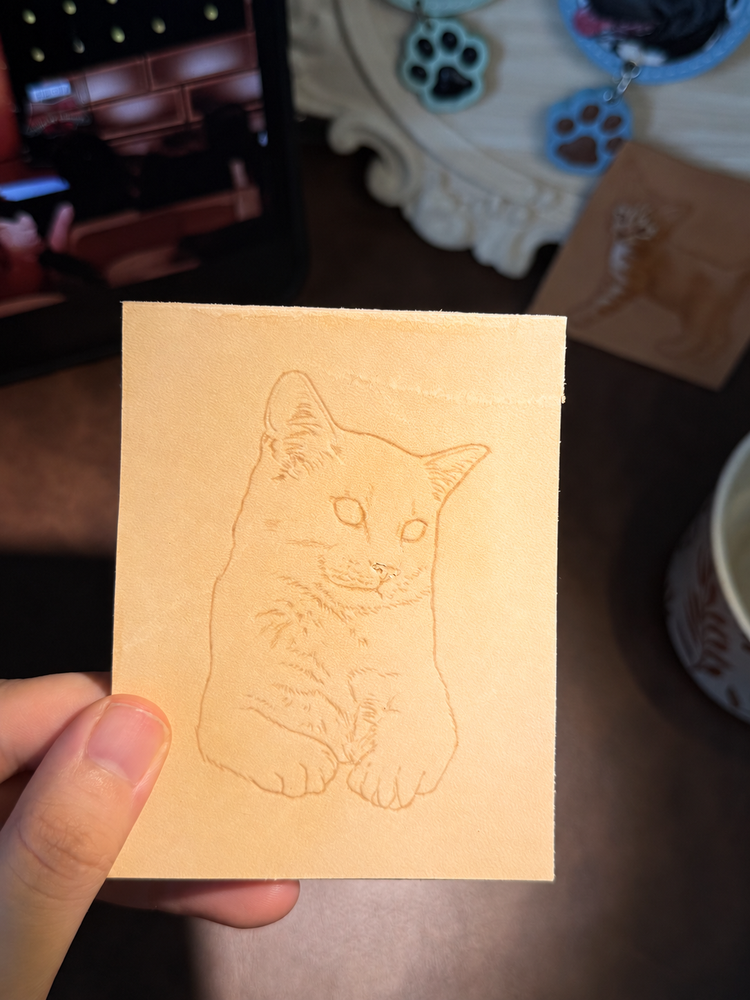 White cat portrait outline transferred onto leather before carving